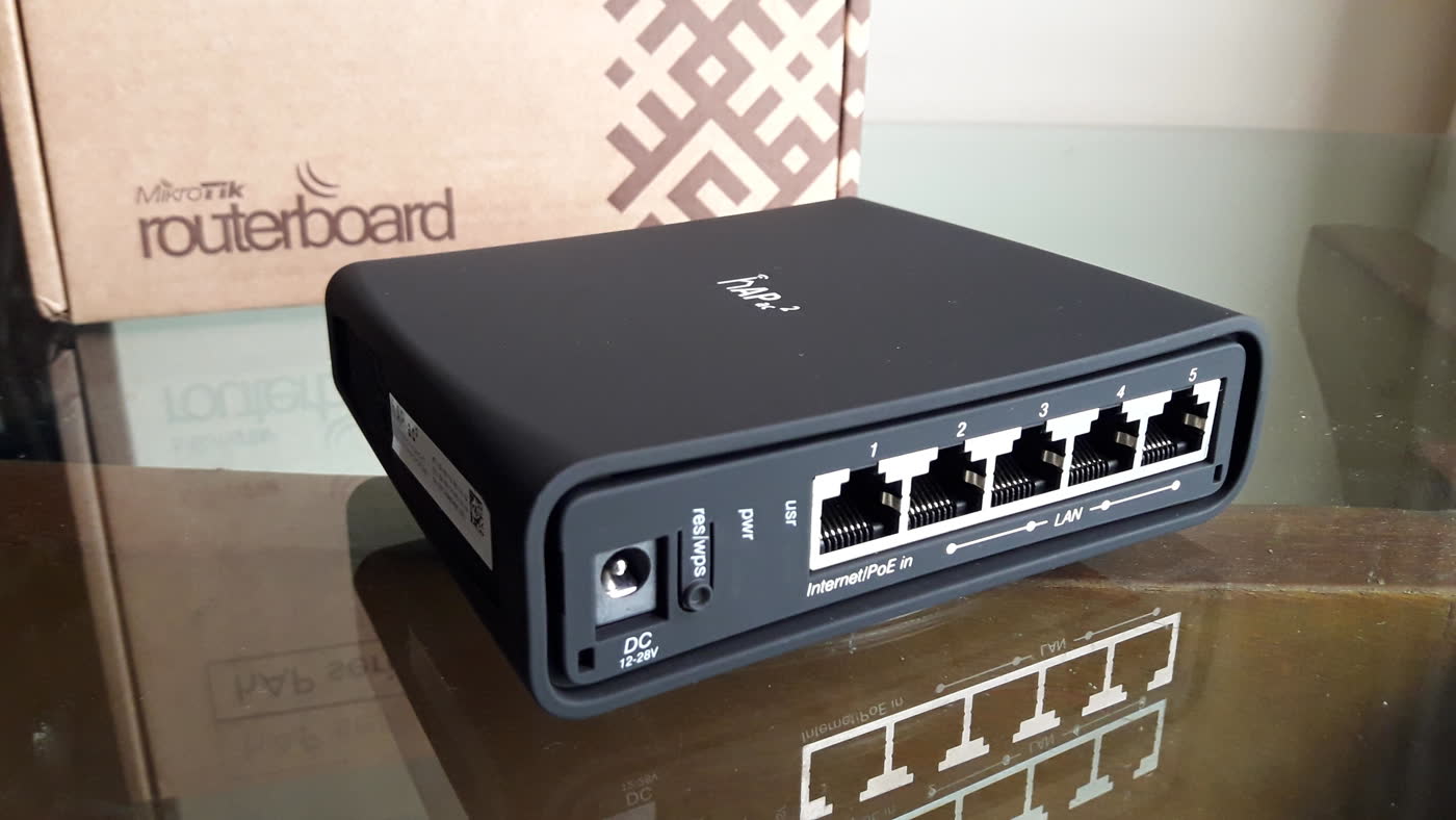 MikroTik hAP ac2 router in front of a RouterBOARD box.